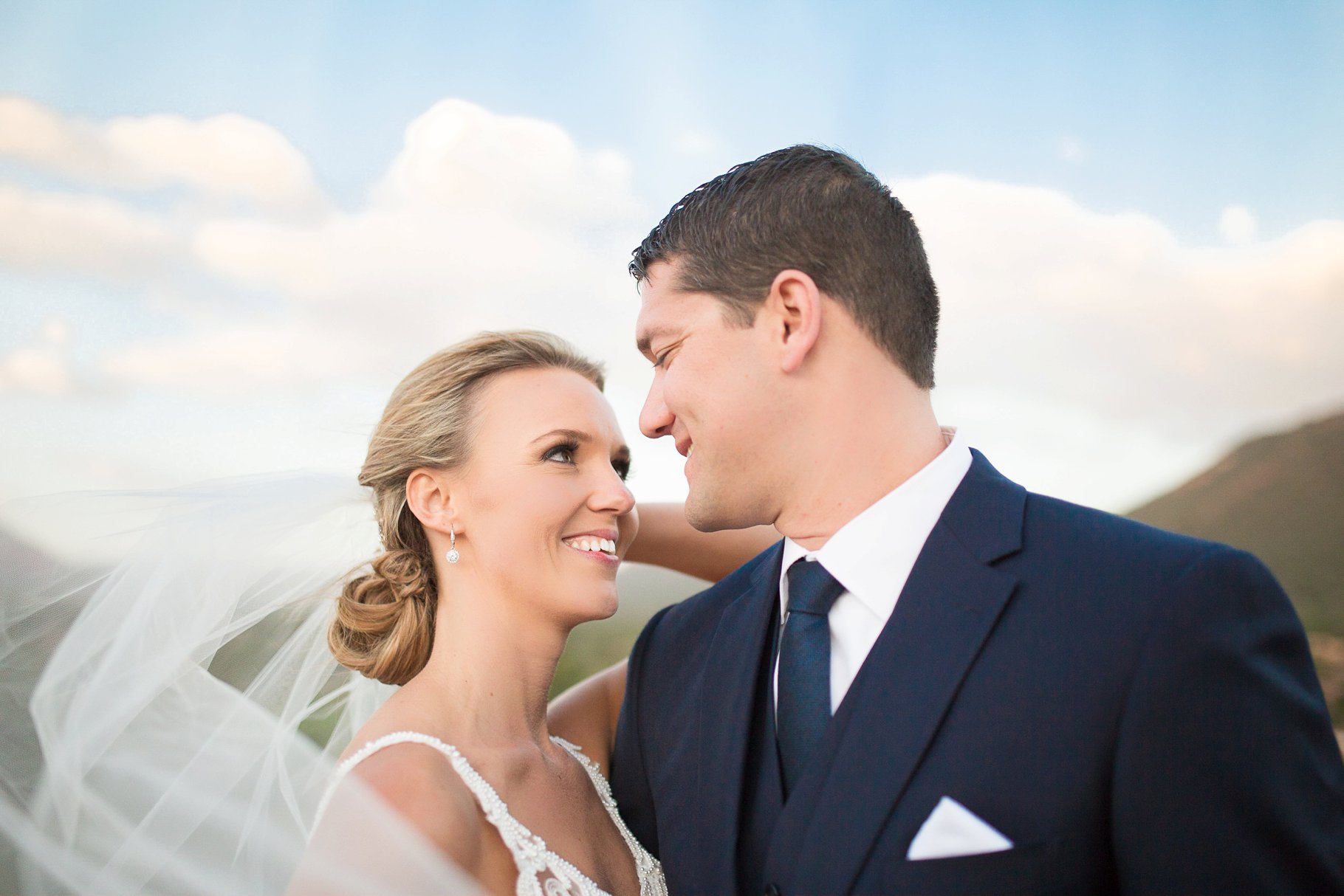 wind blowing brides veil with Sedona in backdrop