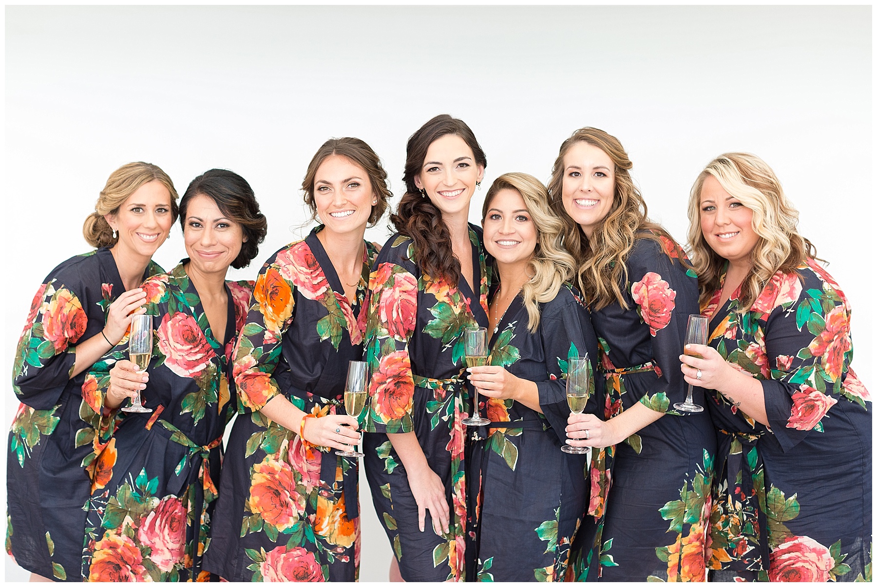 Bridesmaids in floral robes with champagne