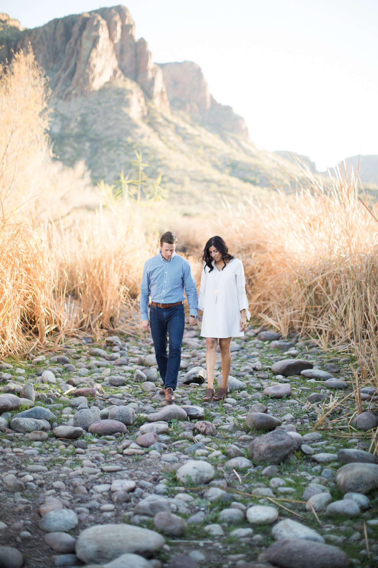 Couple holding hands walking at Saguaro Lake