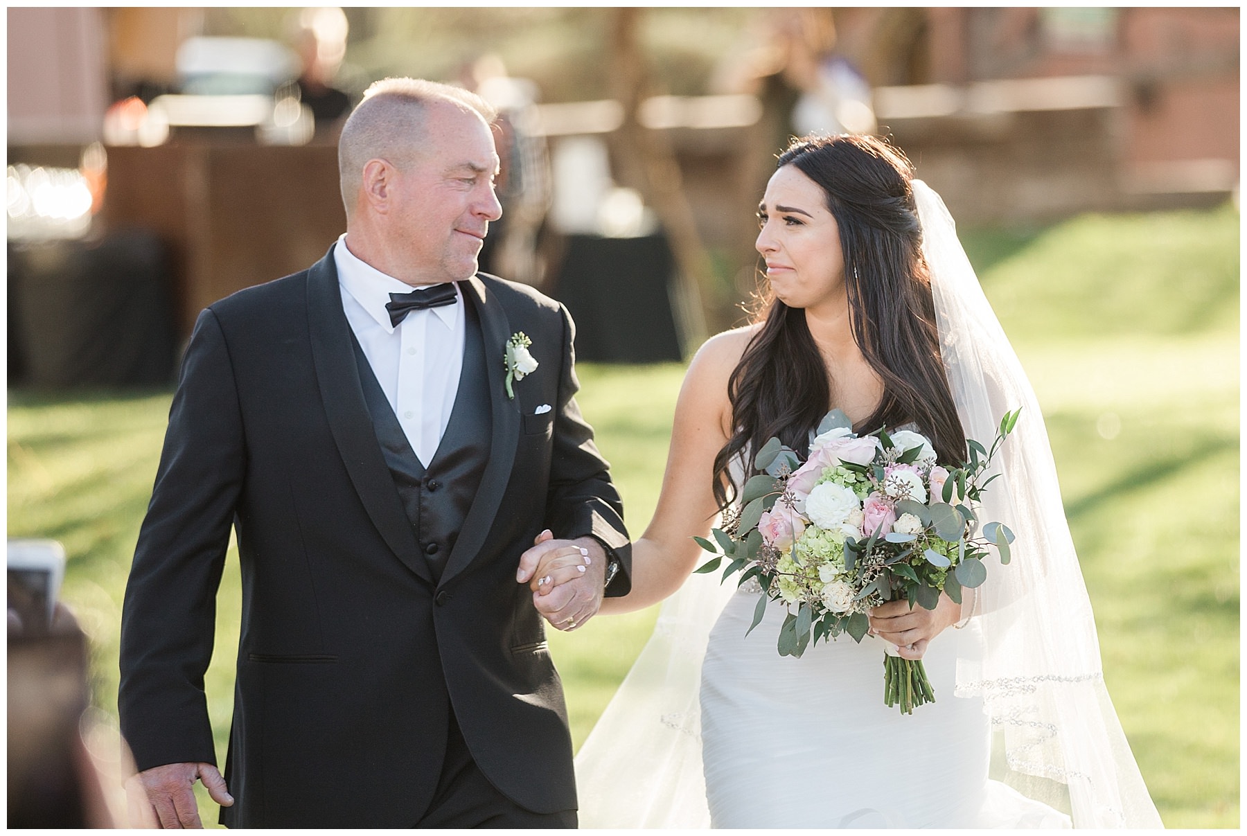 Emotional Bride and Father walking down aisle at wedding