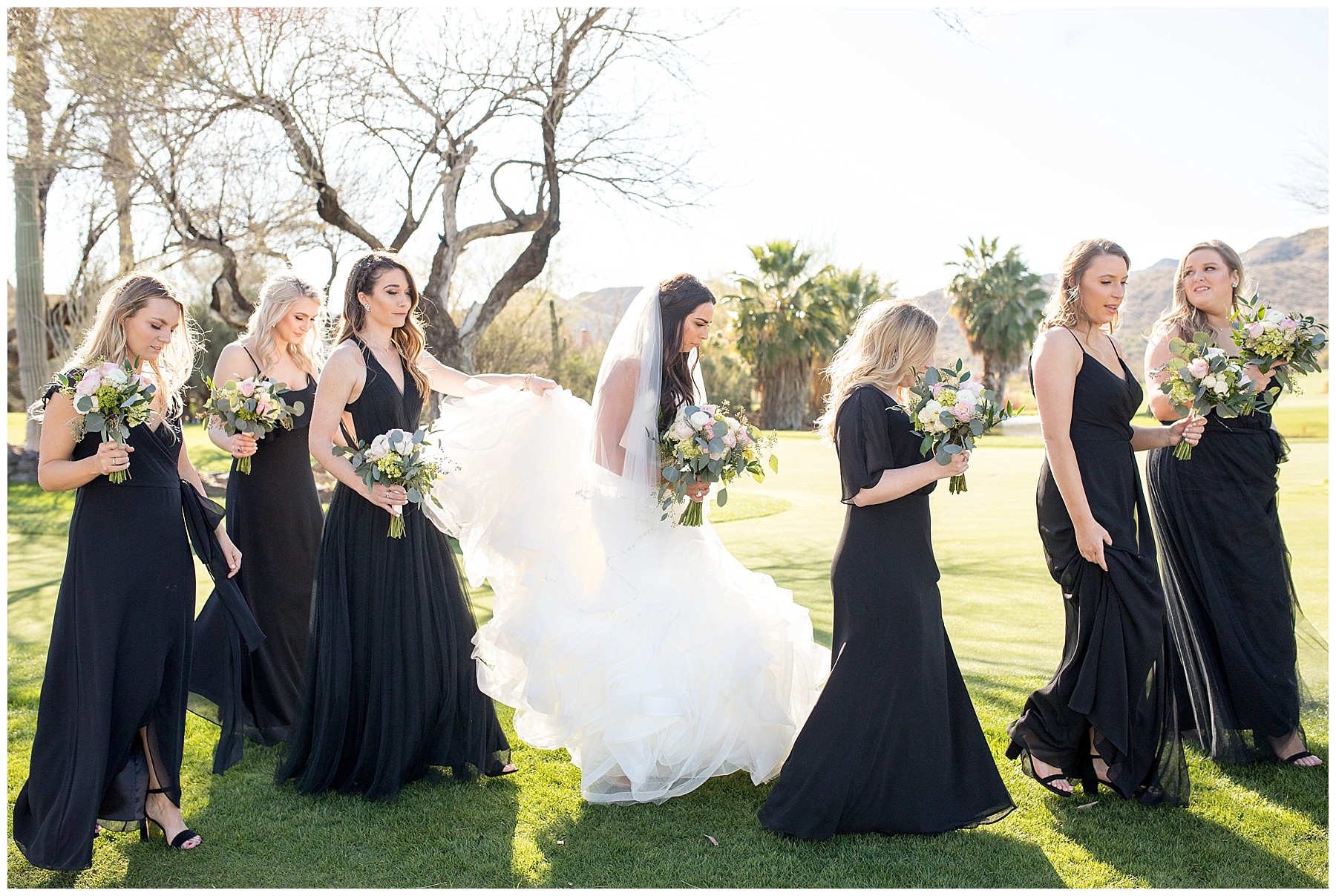 Bridemaids in Black Watters dresses walking with Bride